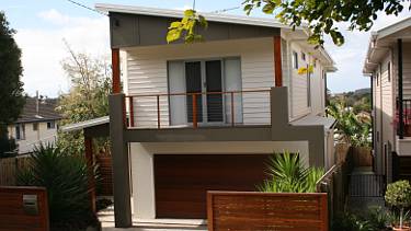 Two storey house, with a double garage underneath, on a sub-divided lot.